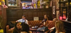a group of people sitting on a couch in a bar at Watervalley Farm Self Catering in Cloongawn