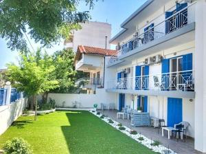 a courtyard of a building with a grass yard at Sea Breeze 202 in Neoi Epivates