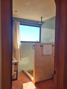 a bathroom with a shower with a window at La Bocania in Progreso +35 photos