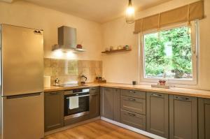a kitchen with stainless steel appliances and a window at RomaOlyaHouse in Budva +19 photos
