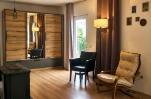 a living room with two chairs and a mirror at RomaOlyaHouse in Budva