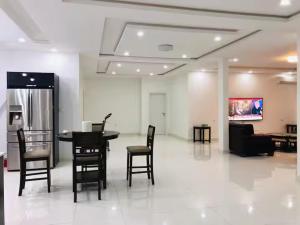 a room with a table and chairs and a couch at Appartement spacieux 3 chambres in Nouakchott