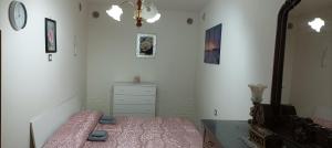 a bedroom with a bed and a dresser and a mirror at Casa Nonna Trentina in Melfi