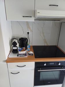 a kitchen with a counter with a stove top oven at Skylight46 La Terrasse St Louis in Saint-Louis