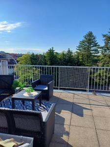 a patio with a chair and a table on a balcony at Skylight46 La Terrasse St Louis in Saint-Louis