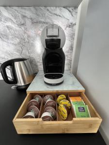 a coffee maker and a box of chocolates at ValenStay - Maison groupes ou famille - Netflix in Anzin