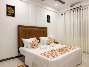 a bedroom with a large white bed with flowers on it at Shelo Transit Hotel in Katunayaka +61 photos