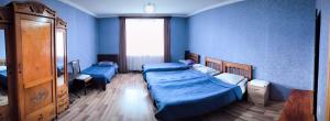 A bed or beds in a room at Kamara Guest House