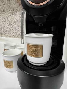 a coffee cup sitting on top of a coffee maker at Little Paradise in Castro Marim