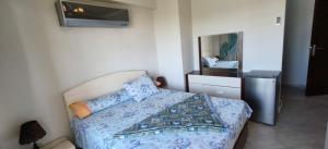 a bedroom with a bed with blue sheets and a mirror at Aqua View Chalet at Piacera Resort-Ain Sokhna in Ain Sokhna +26 photos