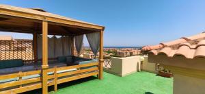 a patio with a gazebo on a roof at Aqua View Chalet at Piacera Resort-Ain Sokhna in Ain Sokhna