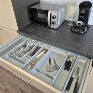 a kitchen counter with a sink and a microwave at Happy Place Apartment XXL in Braunschweig