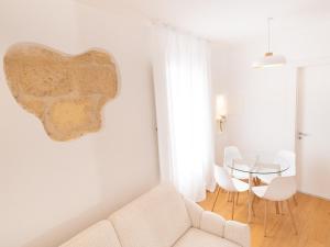 a living room with a couch and a table at Maison Odile in Cefalù +72 photos