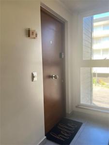 a door in a room with a welcome mat next to a window at Entorno Natural, cerca del centro de Pucón Parking Privado in Pucón +21 photos