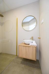 a bathroom with a sink and a mirror at Apartments Sunset Komarna in Komarna +33 photos