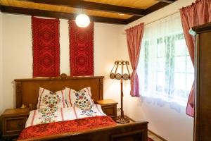 a bedroom with a bed with red curtains at Zanurzeni w Ciszy in Nowe Motule