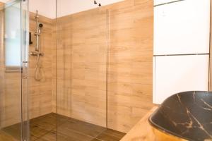 a shower stall with a glass door in a bathroom at Zanurzeni w Ciszy in Nowe Motule