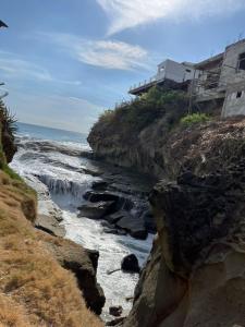 a river with water rushing down a rocky cliff at Pelican House in Rivas +17 photos