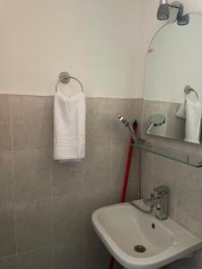a bathroom with a sink and a white towel at Casa Melania in Eşelniţa +23 photos