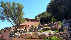 a large rock garden in front of a house at Appartement Cemiliana in Bonifacio