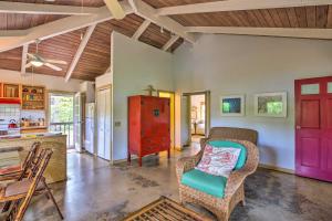 a living room with a red door and a chair at Kauai Hale Melemele by Coldwell Banker Island Vacations in Kapaa
