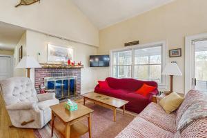 a living room with a red couch and a fireplace at The Betty in Jackson