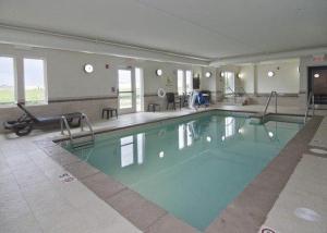 a large swimming pool in a building at Sleep Inn & Suites Marshall in Marshall