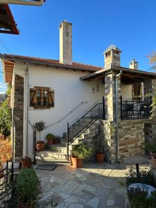 a house with a staircase in front of it at Vines & Views in Ano Volos