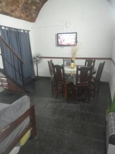 a dining room with a table and chairs at Pilar in Santa Teresita