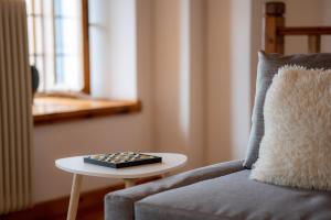 a remote control sitting on a table next to a couch at Vines & Views in Ano Volos