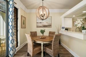 a dining room with a table and chairs at Kauai Kiahuna Plantation #402 by Coldwell Banker Island Vacations in Koloa