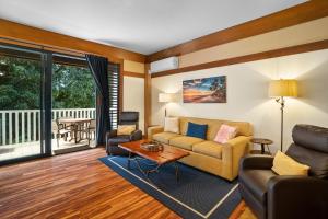 科洛阿Kauai Kiahuna Plantation #425 by Coldwell Banker Island Vacations的客厅里有一张沙发和一张桌子。