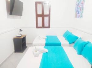 a room with a bed with blue and white at Agradable apto en el centro histórico in Cartagena de Indias