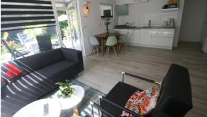 a living room with a couch and a table at Palm tree house in Lemmer