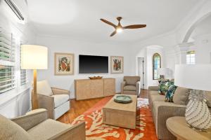 a living room with a couch and a tv at Kauai Wainani Villa by Coldwell Banker Island Vacations in Koloa