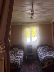 a bedroom with two beds and a window at guest house welcome in Khulo