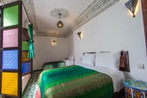 Postel nebo postele na pokoji v ubytování Riad Taha