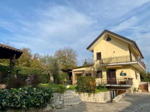 a yellow house with a balcony and a fence at GuesthouseAntonia in Avellino