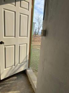 an open door with a field in the background at Pelican House in Rivas