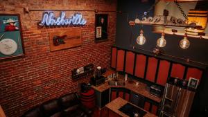 a room with a brick wall and a kitchen with a counter at The Law Suites in Nashville