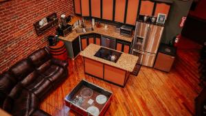 an overhead view of a kitchen with a couch and refrigerator at The Law Suites in Nashville +23 photos