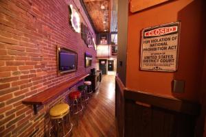 a bar with stools in a room with a brick wall at The Law Suites in Nashville