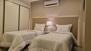 Llit o llits en una habitació de ABIBA Apart-Hotel & SPA