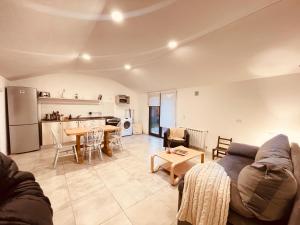 a living room with a couch and a table at Los Coirones 3 - Cabaña con jardin in Dina Huapi