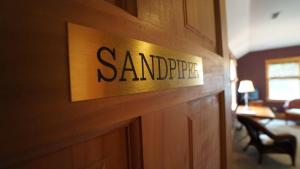 a sign on the wall of a hotel room at Cameron House Next Door in Manteo