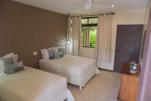 a hotel room with two beds and a window at Hotel Diriá Santa Cruz in Santa Cruz +90 photos