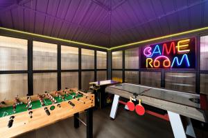 a room with a ping pong table and a game room at Waterfront Villa with Beach, Game Room, Cinema and Spa in Pembroke Pines