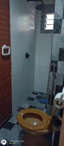 a bathroom with a brown toilet in a room at Alboroto house in Santa Clara del Mar +15 photos