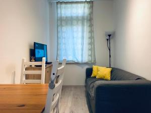 a living room with a couch and a window at Cozy Place with a Balcony in Bratislava