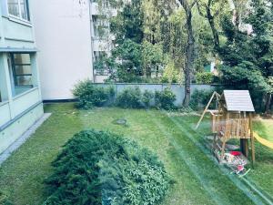 a yard with a swing set in the grass at Cozy Place with a Balcony in Bratislava